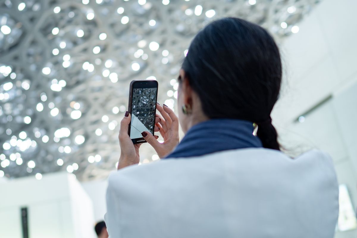 A person photographing a room's interior with a phone to document its condition.