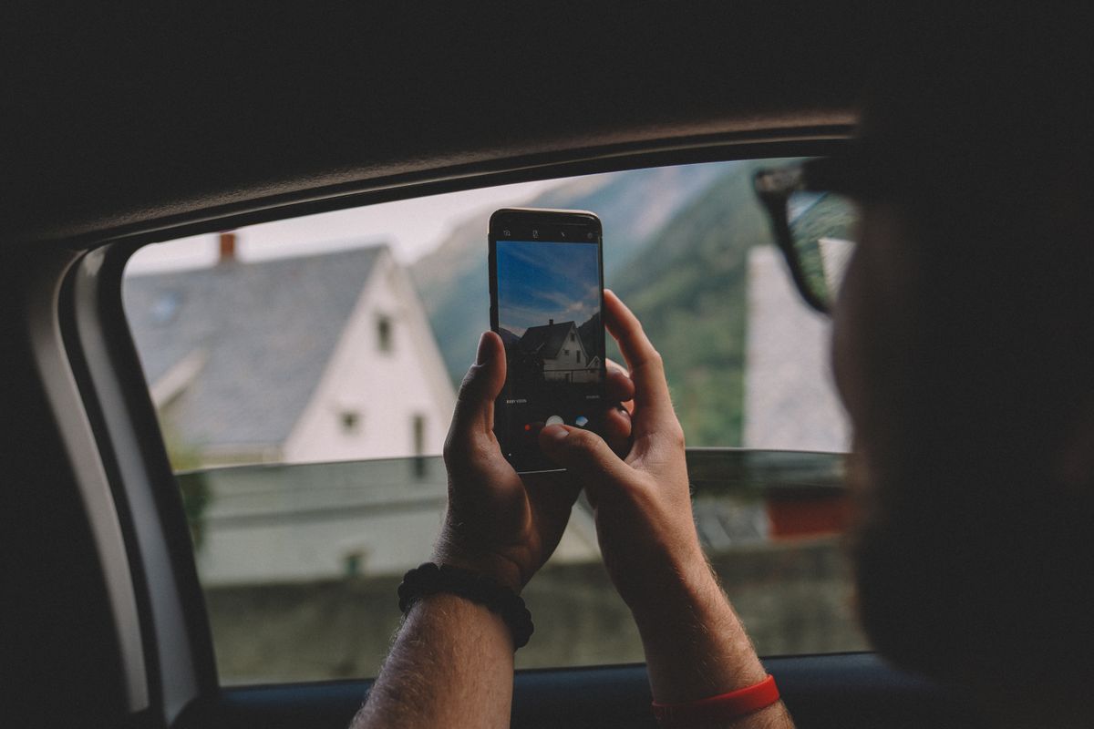 A worker taking a photo on a phone at the moment of the job