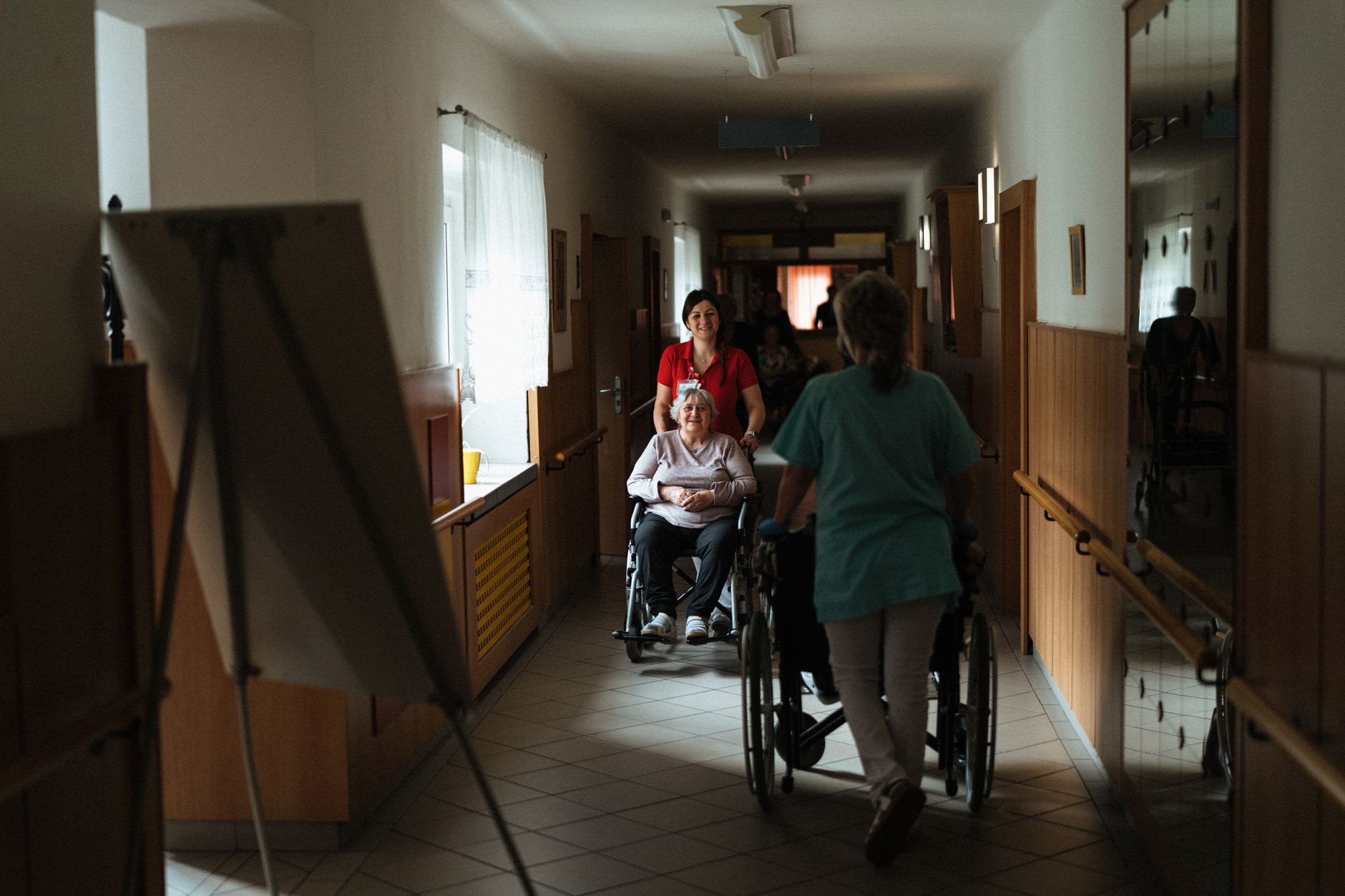 A home-care aide assisting an older adult during an in-home visit