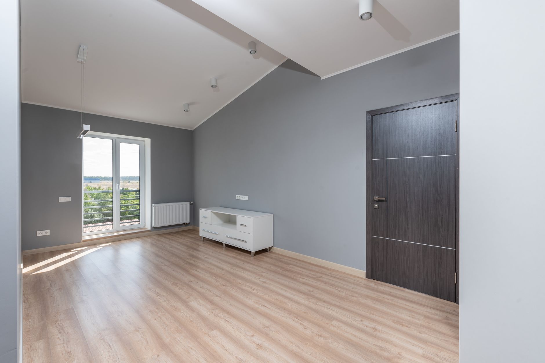 An empty apartment unit with wood floors, cleared and ready for a new tenant