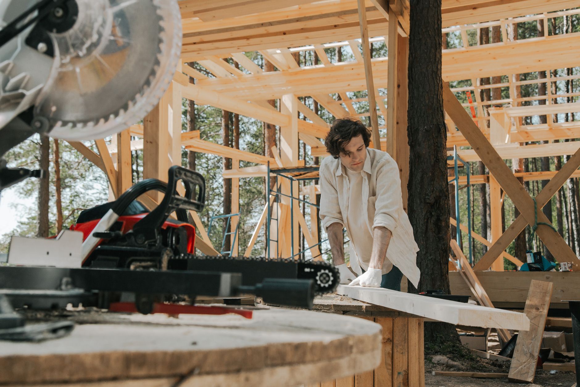 A tradesperson working on a wooden structure at a job site