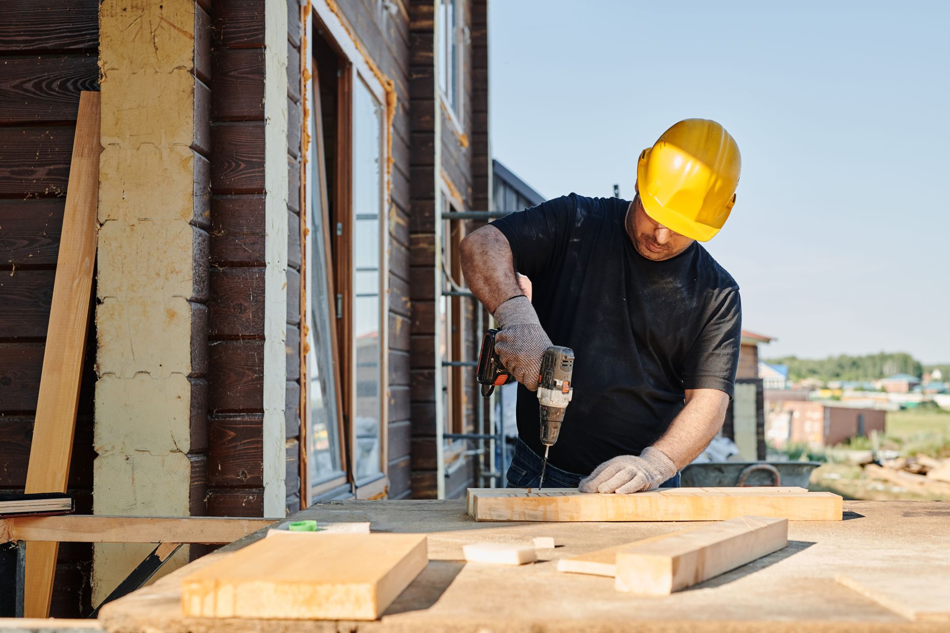 A worker using a power tool on a job site, the moment a proof photo would capture