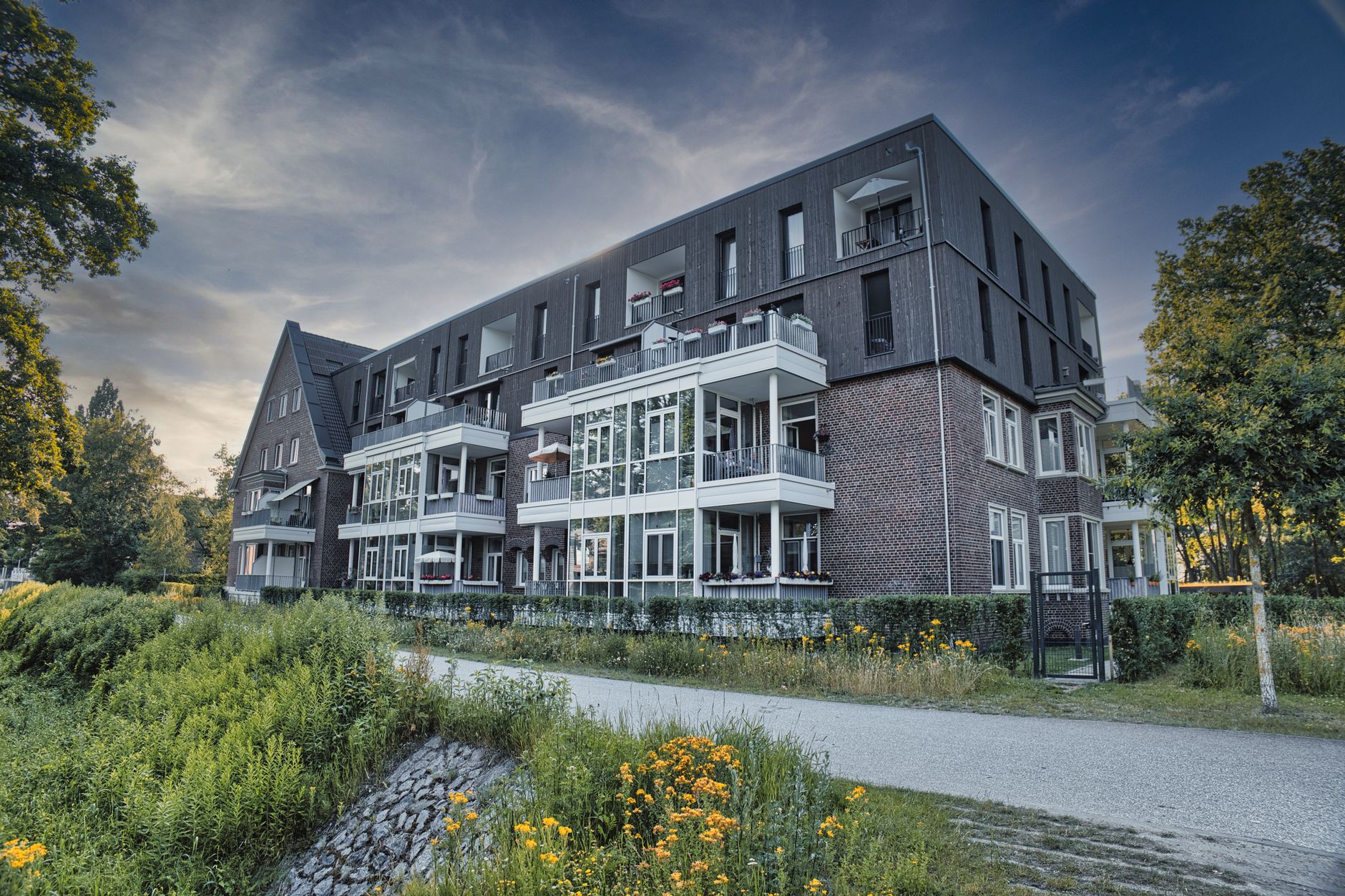 A residential building exterior surrounded by greenery