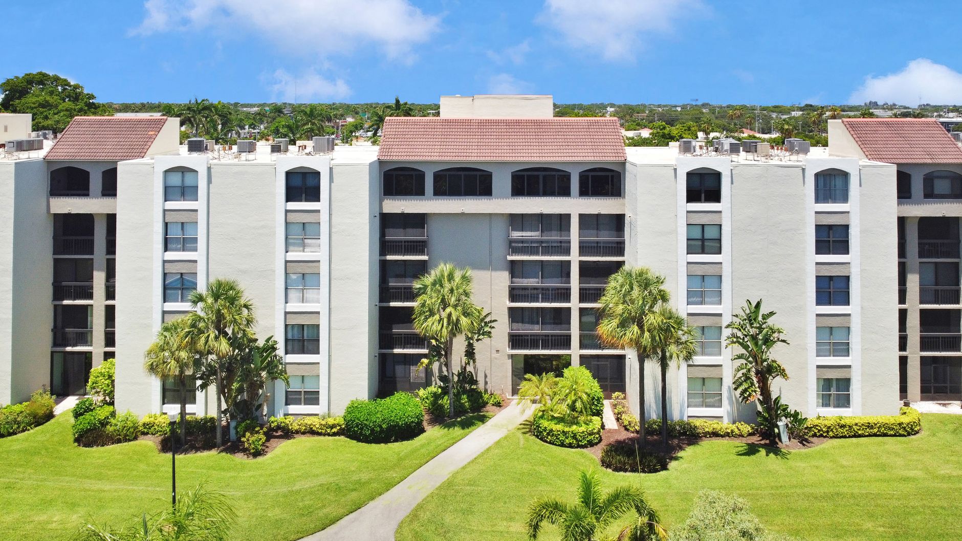 A residential community building with lawns and mature planting