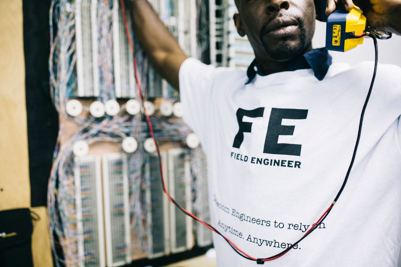 A field service technician working on equipment at a job site